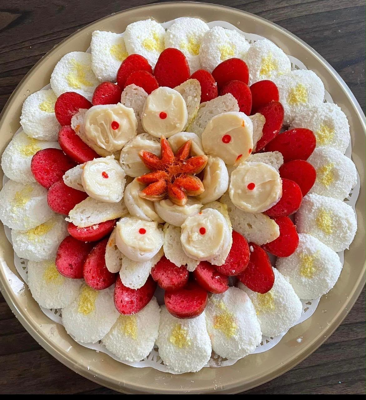 White and red sandesh platter with cream centerpiece