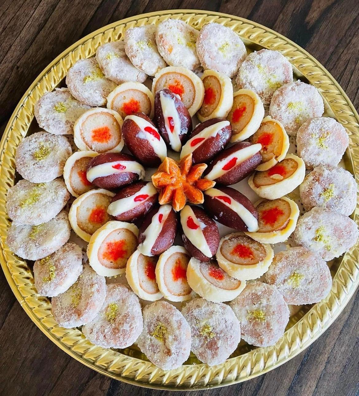 Pinwheel sandesh platter with cream-filled gulab jamun centerpiece