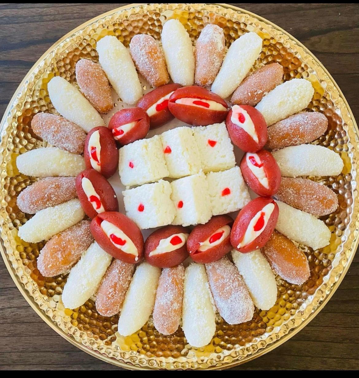 Chum chum and cream-filled red sweets around a sandesh center