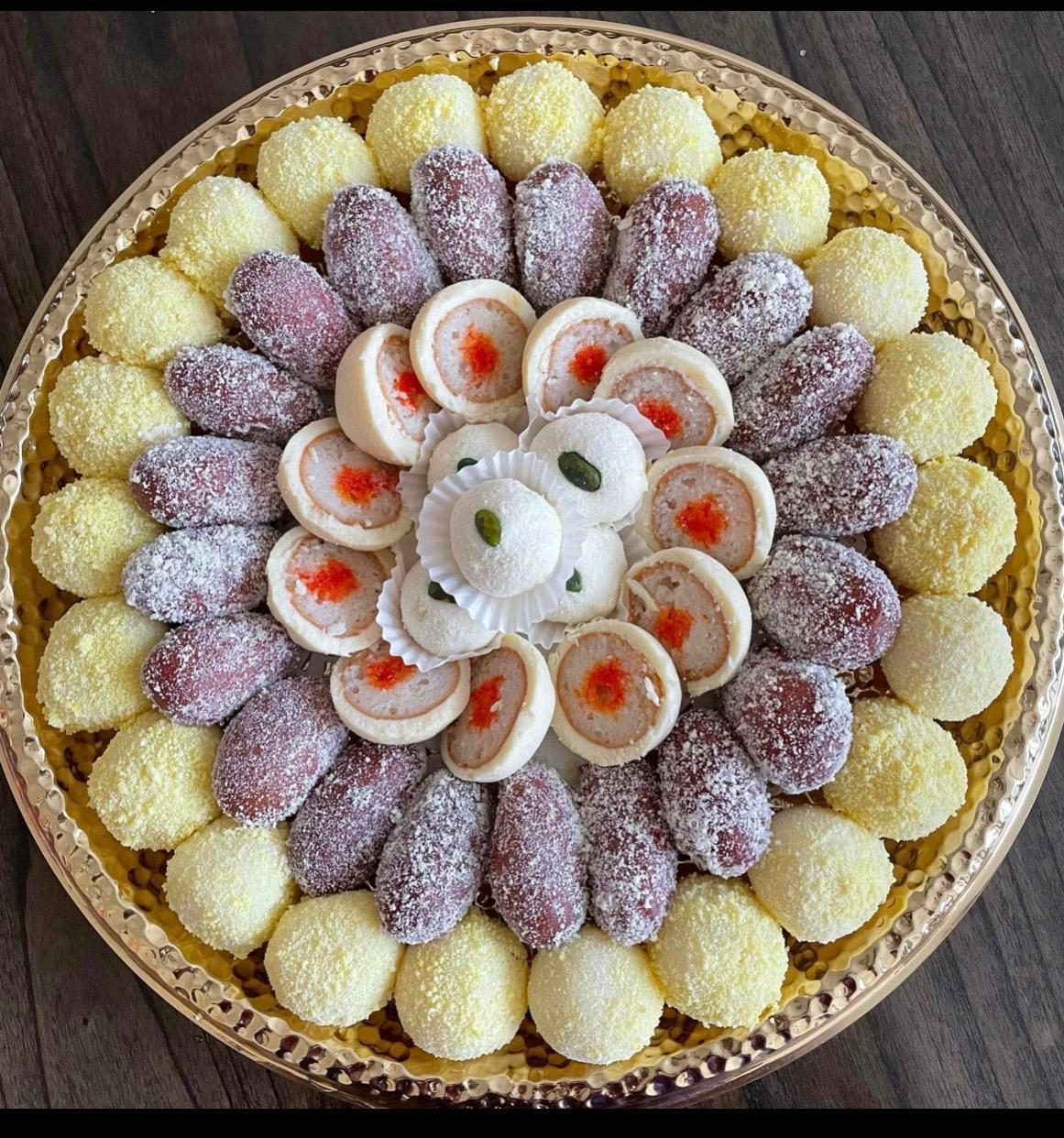 Yellow ras malai and chum chum platter with pinwheel sandesh center